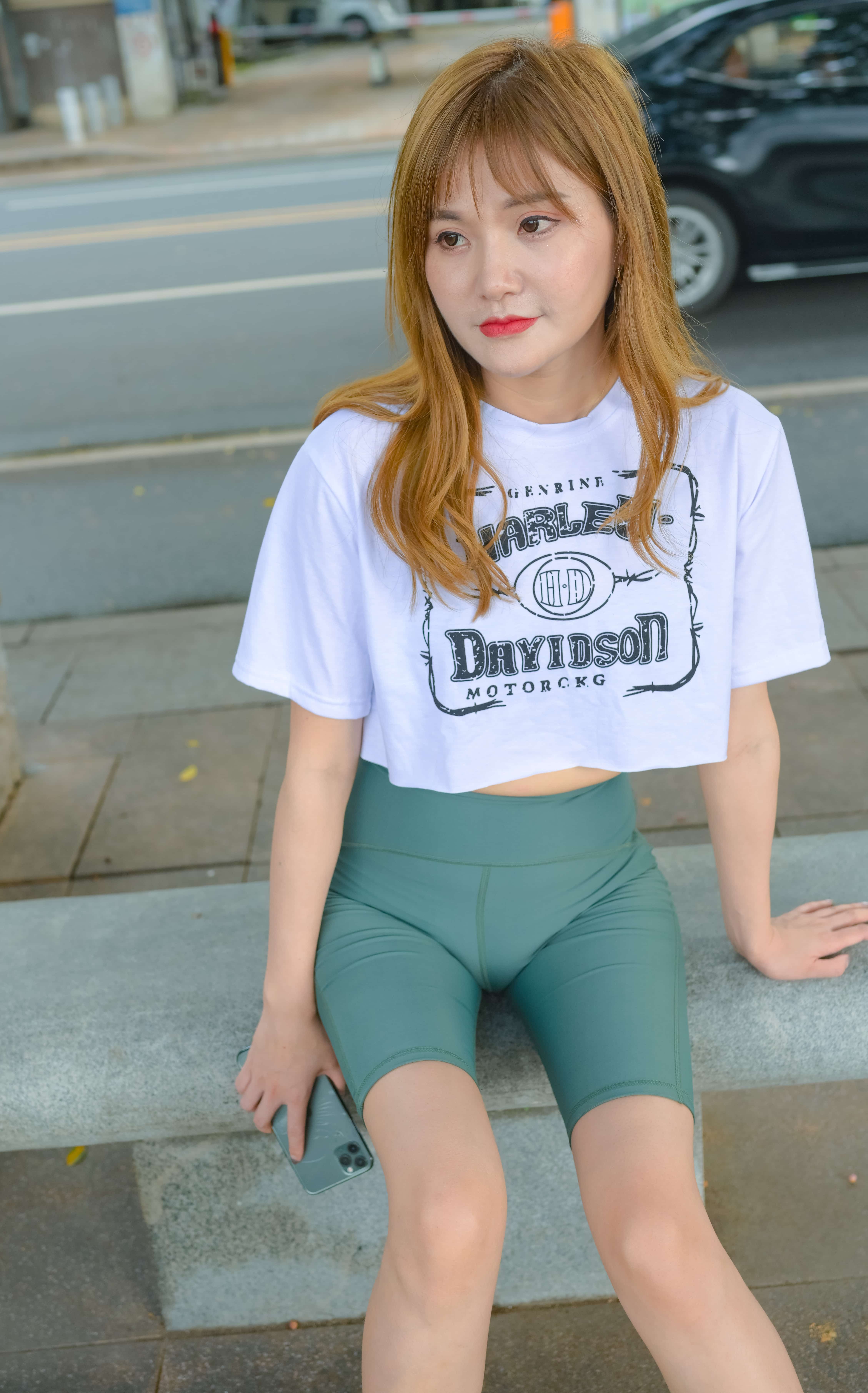 Playful scene of socks draped near yoga props as Anna stretches, toes pointed and nylon glinting in soft studio light.